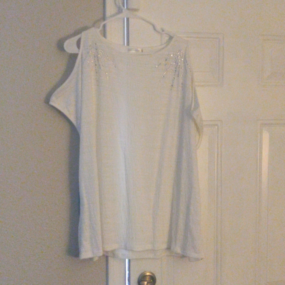 White blouse with sequins off the shoulder.
